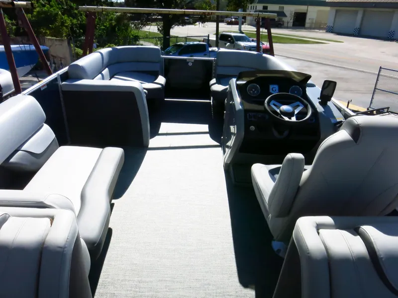 Slide: The Image of 2024 Godfrey Monaco 235SD pontoon boat interior with spacious seating and modern helm. - 7