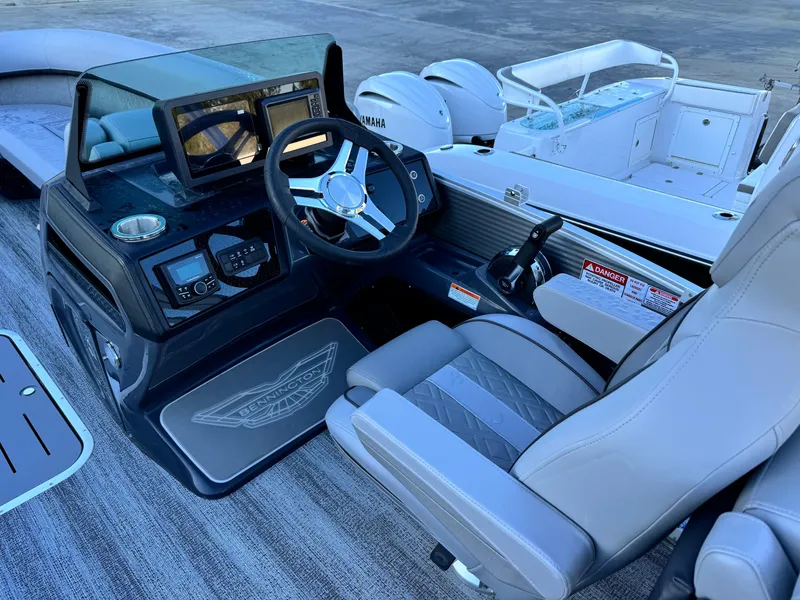 Slide: The Image of 2025 Bennington 24 MFB boat interior with steering wheel and control panel. - 13