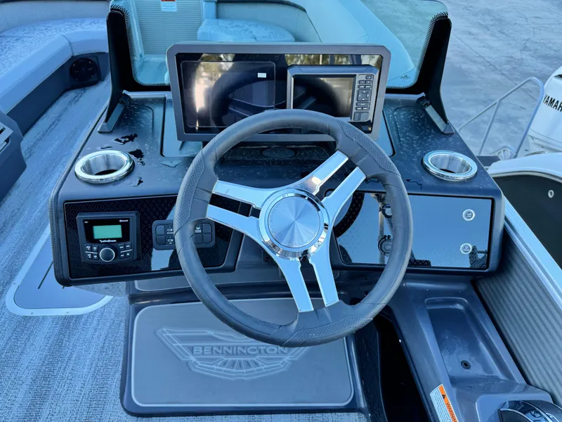 Slide: The Image of 2025 Bennington 24 MFB boat dashboard with steering wheel and digital displays. - 15