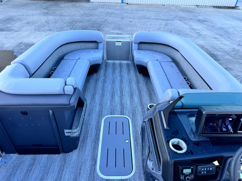 Slide: The Image of 2025 Bennington 24 MFB pontoon boat interior with spacious seating and modern dashboard. - 17