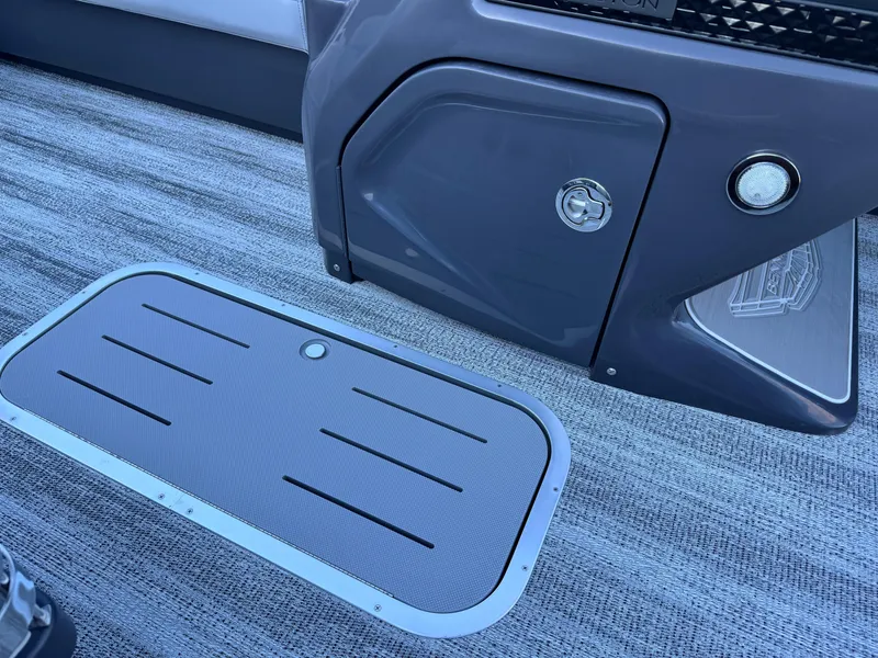Slide: The Image of 2025 Bennington 24 MFB boat interior with storage compartment and textured flooring. - 22