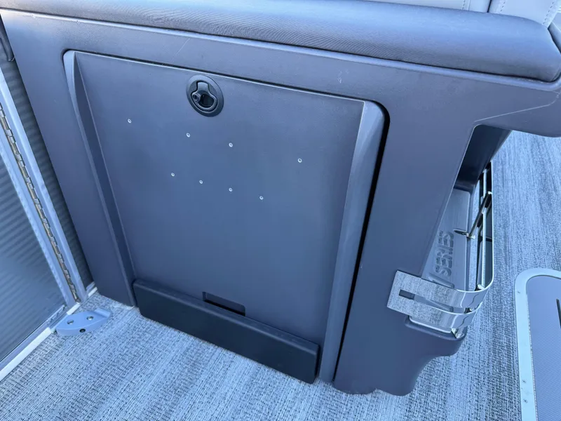 Slide: The Image of Bennington 24 MFB 2025 boat interior storage compartment with cup holder. - 23