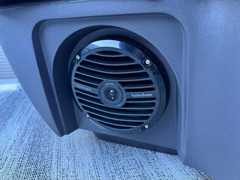 Slide: The Image of 2025 Bennington 24 MFB boat speaker, black grille, mounted on textured surface. - 25