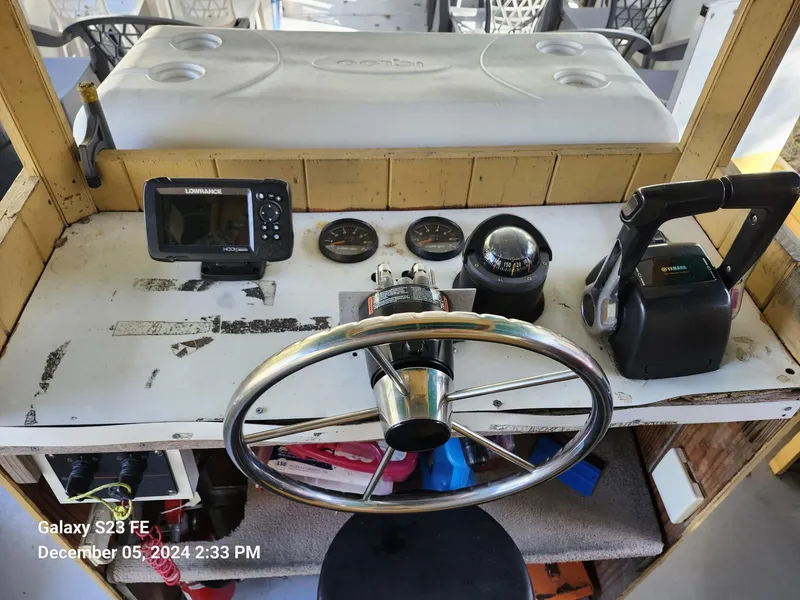 Slide: The Image of Control panel of 2016 Rover Marine Carolina Rover 40 with steering wheel and navigation equipment. - 13