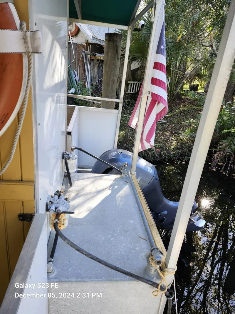 Slide: The Image of 2016 Rover Marine Carolina Rover 40 docked with American flag and life preserver. - 18