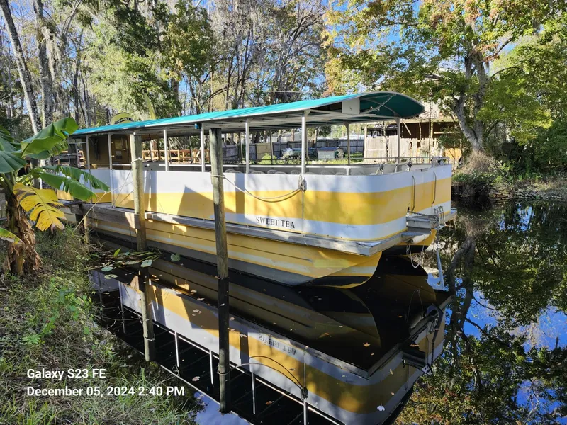 Slide: The Image of Yellow and white 2016 Rover Marine Carolina Rover 40 boat docked on a serene river. - 3