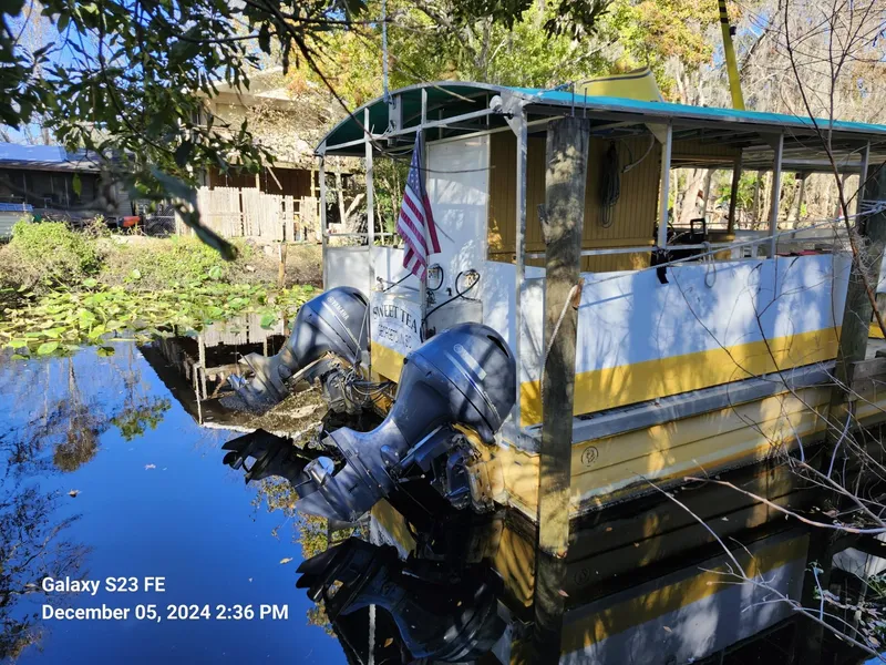 Slide: The Image of 2016 Rover Marine Carolina Rover 40 docked on a serene waterway with lush surroundings. - 4