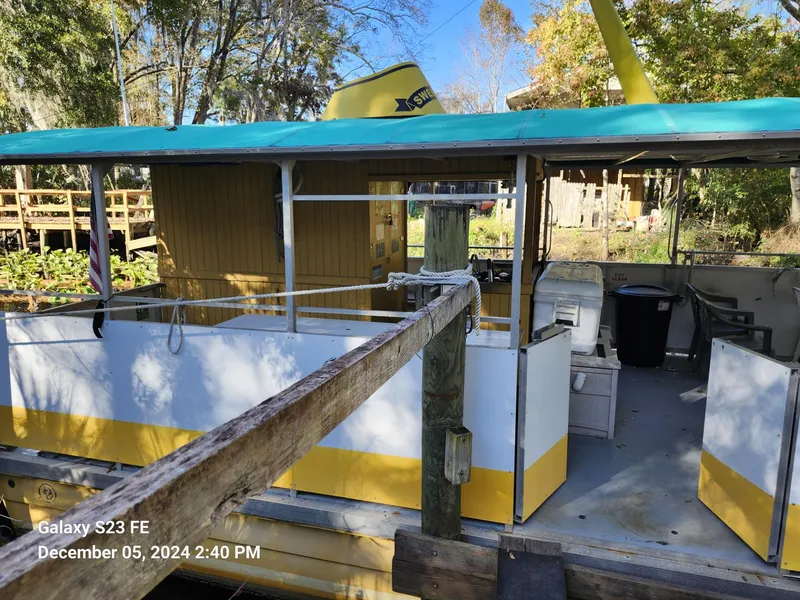 Slide: The Image of 2016 Rover Marine Carolina Rover 40 docked, featuring open deck and vibrant yellow accents. - 5