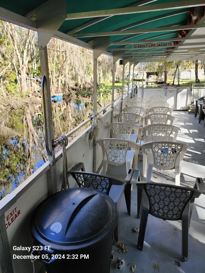 Slide: The Image of 2016 Commercial Rover Marine Carolina Rover 40 boat with seating, docked by a scenic river. - 9