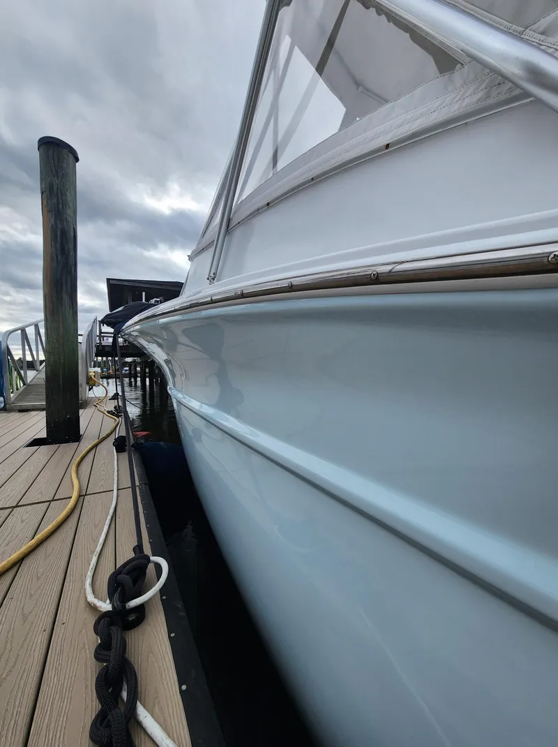 Slide: The Image of Side view of a 1996 Jersey Devil boat docked at a marina. - 11