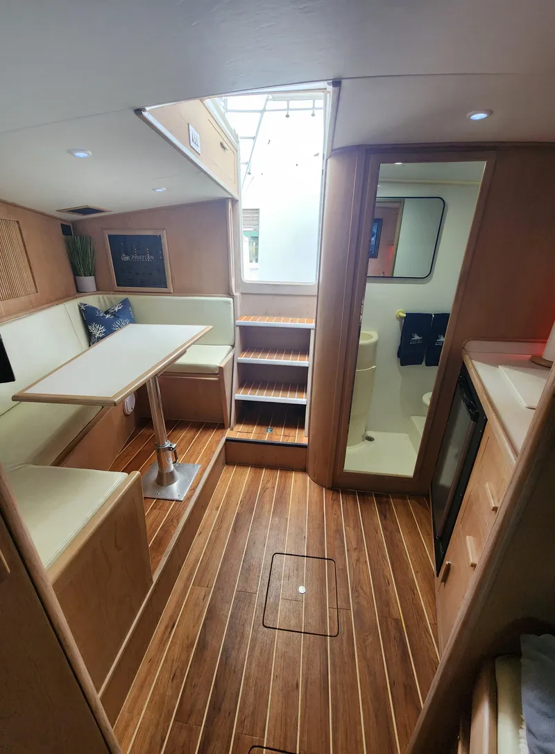 Slide: The Image of Interior of a 1996 Jersey Devil boat with wood flooring and cozy seating area. - 18