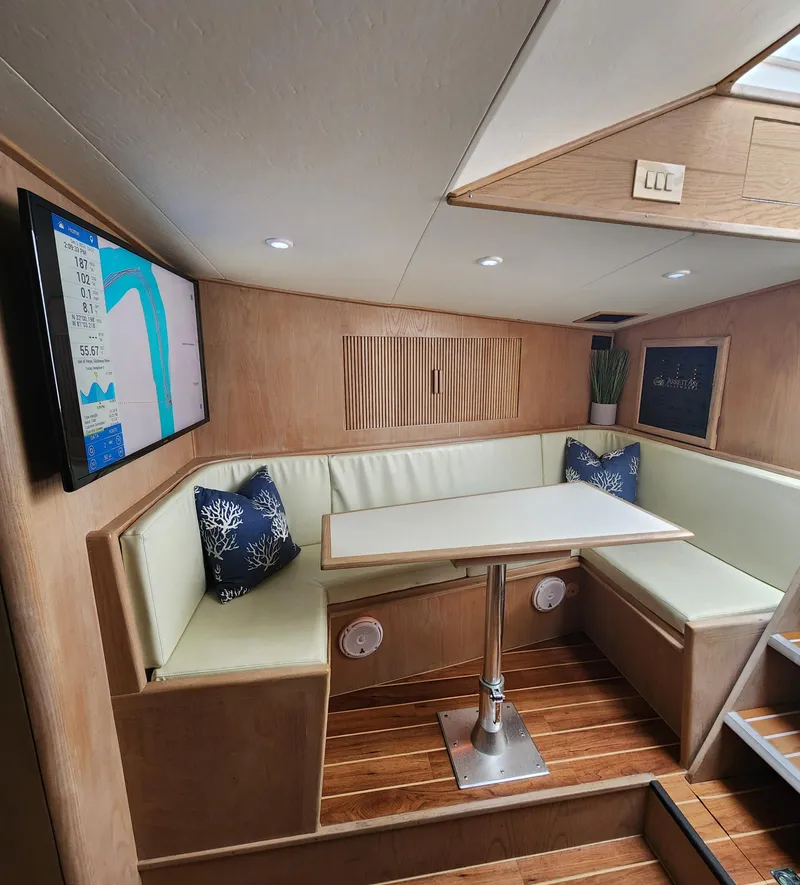 Slide: The Image of Cozy boat interior with seating, table, and wall-mounted screen, Jersey Devil 1996 model. - 20