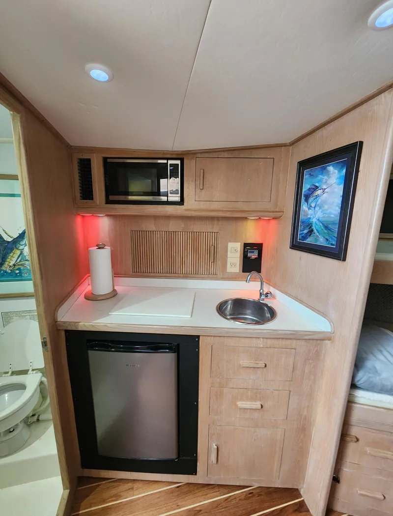 Slide: The Image of Compact 1996 Jersey Devil kitchenette with sink, microwave, mini-fridge, and artwork. - 21
