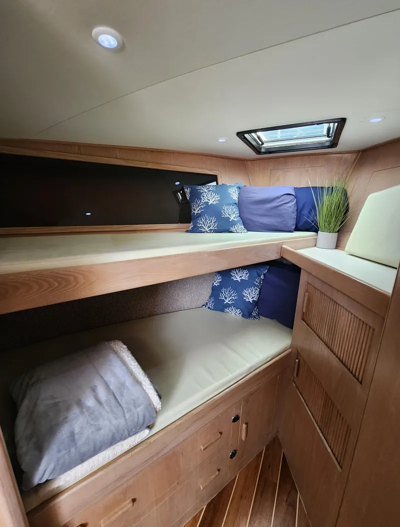 Slide: The Image of Cozy 1996 Jersey Devil boat cabin with wooden bunk beds and nautical decor. - 22