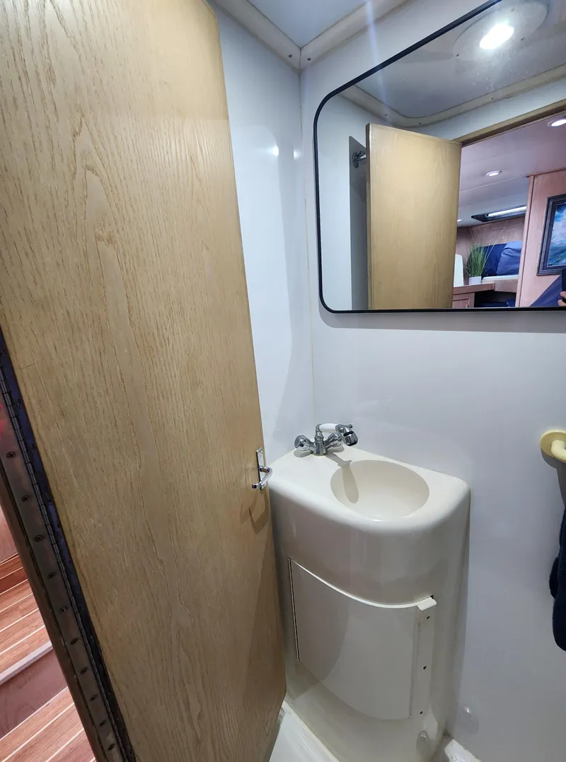 Slide: The Image of Compact bathroom in 1996 Jersey Devil boat with sink and mirror. - 24