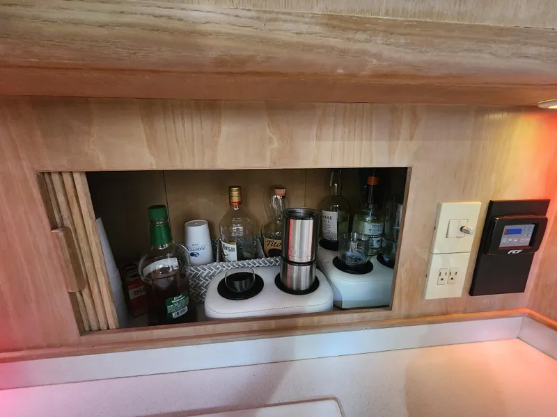Slide: The Image of Wooden cabinet with assorted liquor bottles and glasses, Jersey Devil 1996 model. - 27
