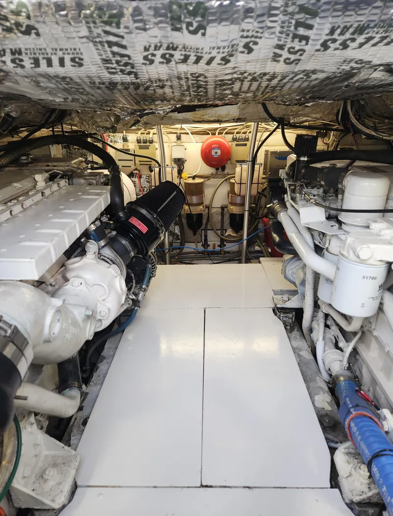 Slide: The Image of Engine room of a 1996 Jersey Devil boat, featuring dual engines and mechanical components. - 29