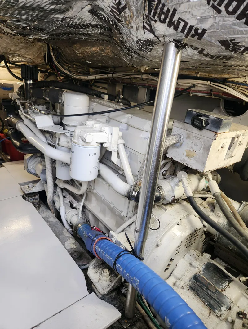 Slide: The Image of Engine room of a 1996 Jersey Devil boat, showcasing complex machinery and piping. - 30