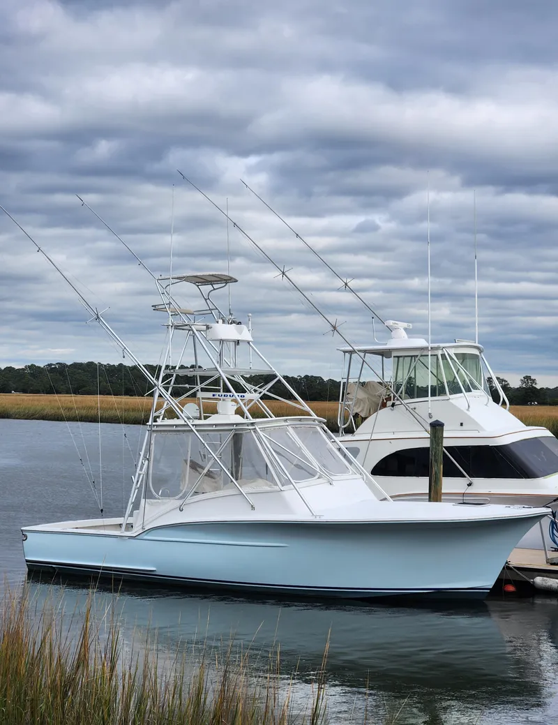 Slide: The Image of 1996 Jersey Devil boat docked on a cloudy day. - 4