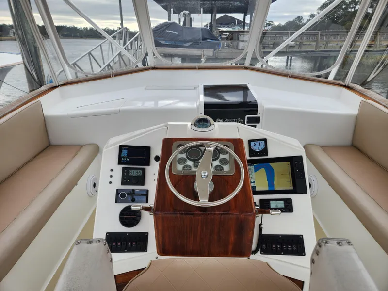 Slide: The Image of 1996 Jersey Devil boat helm with modern navigation equipment and wooden steering wheel. - 7