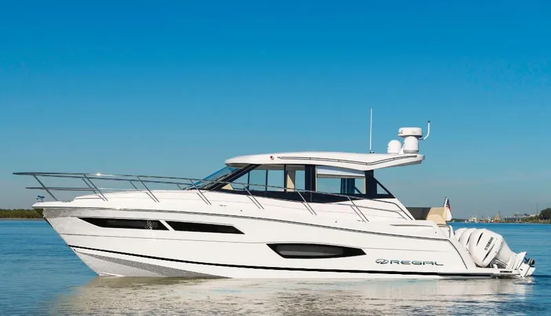 The Image of 2026 Regal 38 XO yacht docked at marina under clear blue sky. - 0