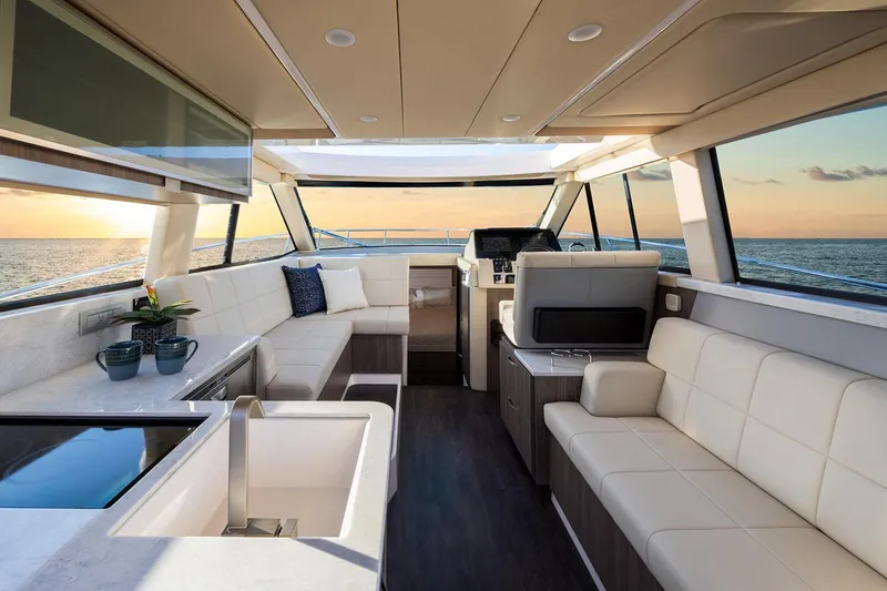 Slide: The Image of Interior of 2026 Regal 38 XO yacht with TV and wooden cabinetry. - 42