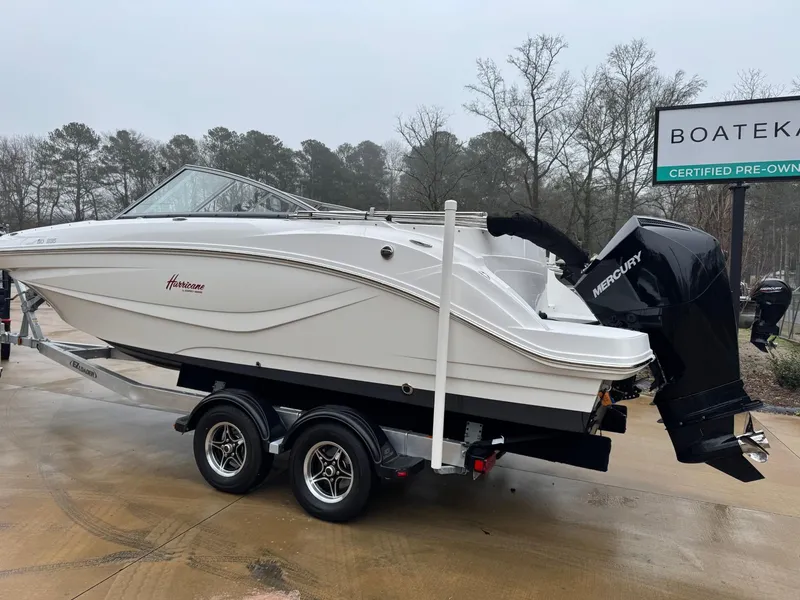 Slide: The Image of 2022 Hurricane SunDeck 235 OB boat on trailer, displayed at Boateka dealership. - 2