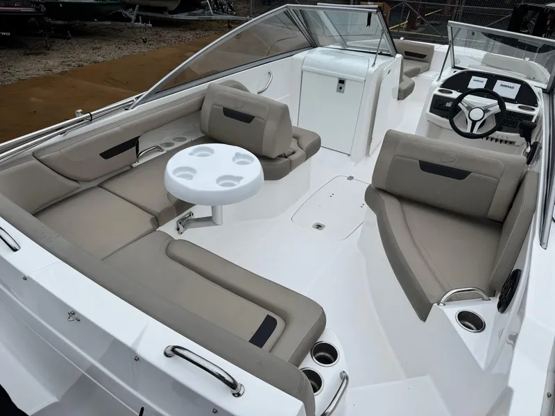 Slide: The Image of 2022 Hurricane SunDeck 235 OB boat on trailer, parked outdoors. - 3