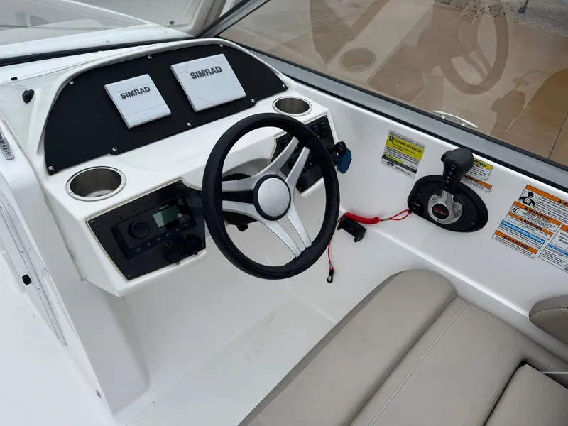 Slide: The Image of 2022 Hurricane SunDeck 235 OB boat interior with spacious seating and modern design. - 7