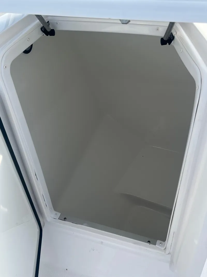 Slide: The Image of 2022 Hurricane SunDeck 235 OB boat dashboard with steering wheel and Simrad displays. - 8