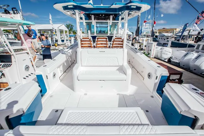 Slide: The Image of 2021 Caymas 401 CC boat interior at a marina, showcasing seating and deck layout. - 15