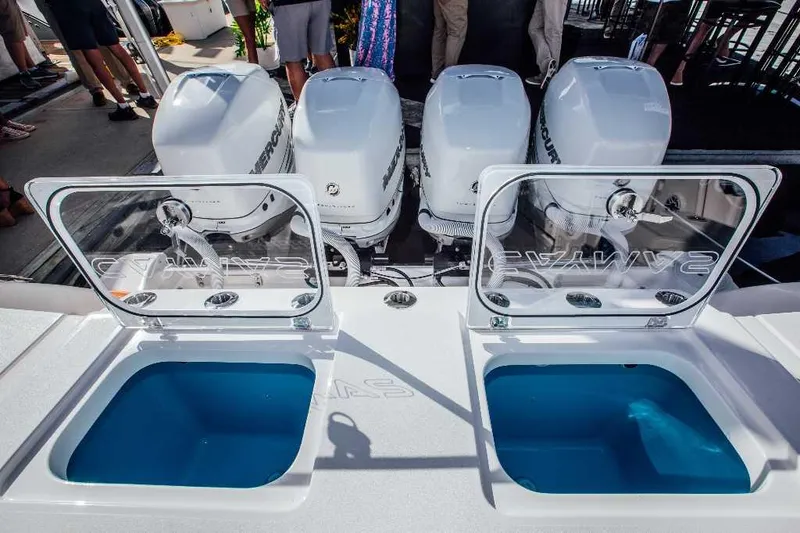 Slide: The Image of 2021 Caymas 401 CC boat with open livewells and powerful outboard engines. - 16