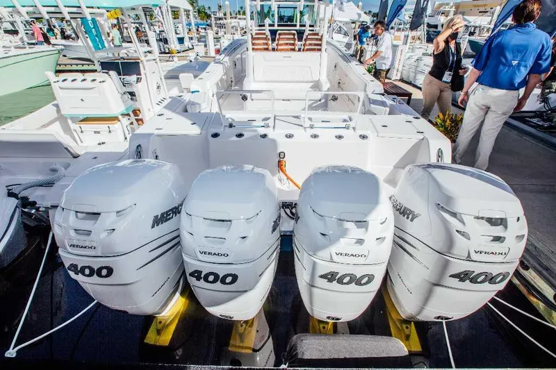 Slide: The Image of 2021 Caymas 401 CC boat with four Mercury Verado 400 engines at a marina display. - 19