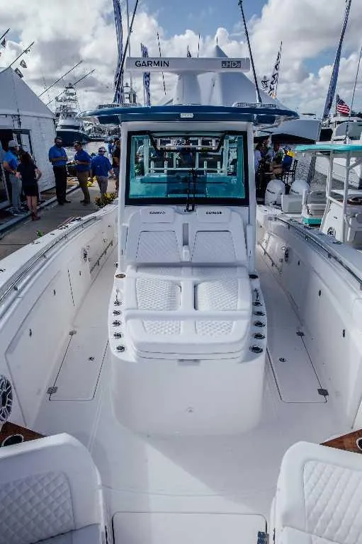 Slide: The Image of 2021 Caymas 401 CC boat with spacious deck and modern design at a marina. - 6