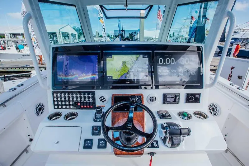 Slide: The Image of 2021 Caymas 401 CC boat dashboard with advanced navigation and control systems. - 8