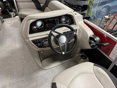 Slide: The Image of 2022 Forest River Trifecta boat dashboard with steering wheel and controls. - 11