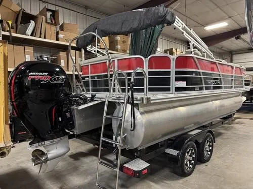Slide: The Image of 2022 Forest River Trifecta pontoon boat with Mercury Pro XS engine in storage. - 3