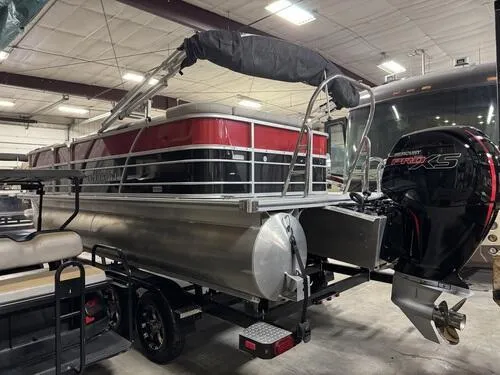 Slide: The Image of 2022 Forest River Trifecta pontoon boat with Mercury outboard motor in a garage. - 4