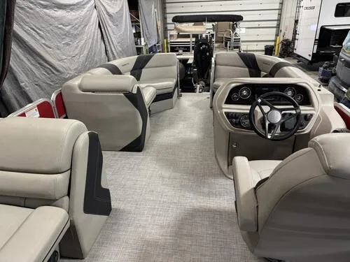 Slide: The Image of 2022 Forest River Trifecta pontoon boat interior with beige seating and modern dashboard. - 7