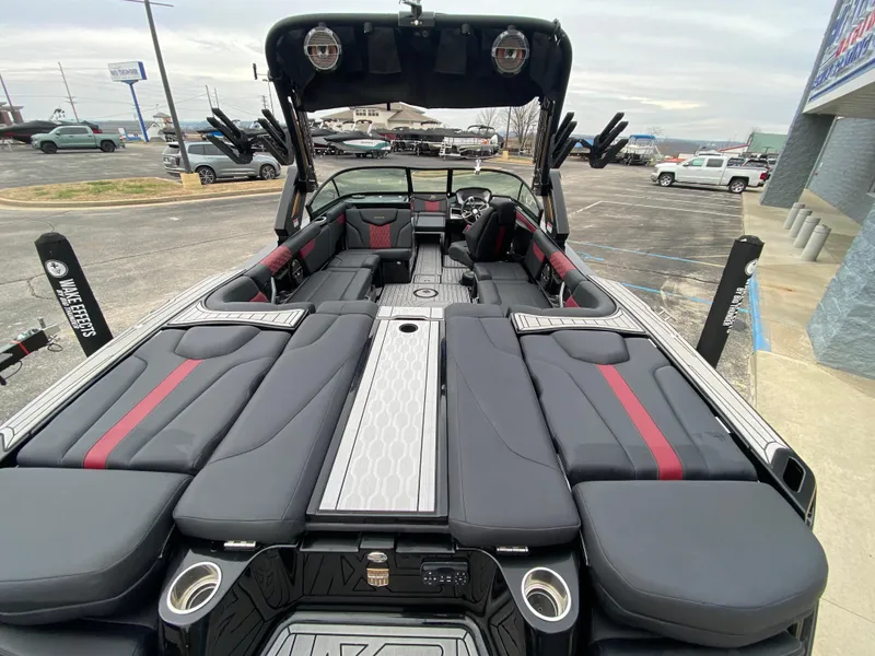 Slide: The Image of 2022 MasterCraft XT24 boat interior with sleek black and red seating, modern design. - 10