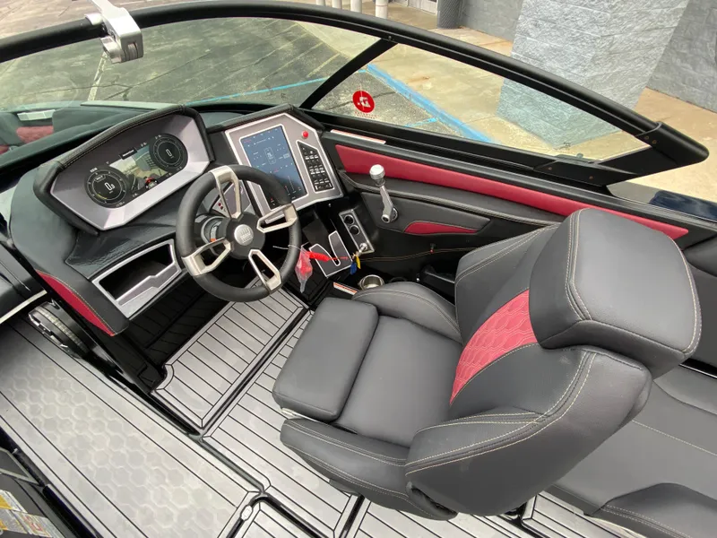 Slide: The Image of 2022 MasterCraft XT24 boat interior with modern dashboard and luxurious seating. - 13