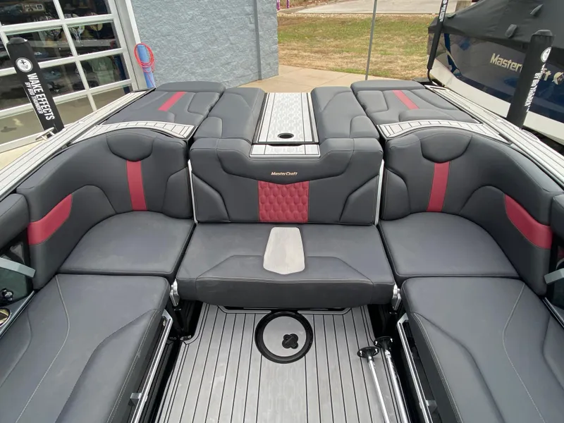 Slide: The Image of 2022 MasterCraft XT24 boat interior with gray and red seating. - 15