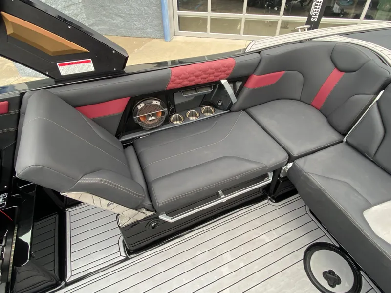 Slide: The Image of 2022 MasterCraft XT24 boat interior with sleek black and red seating. - 17