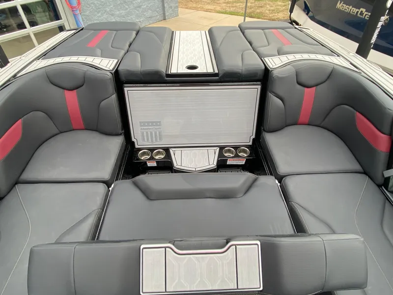 Slide: The Image of 2022 MasterCraft XT24 boat interior with gray and red seating, modern design. - 18