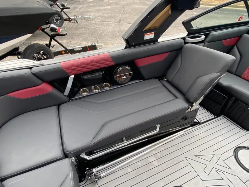 Slide: The Image of 2022 MasterCraft XT24 boat interior with sleek gray and red seating, modern design. - 19