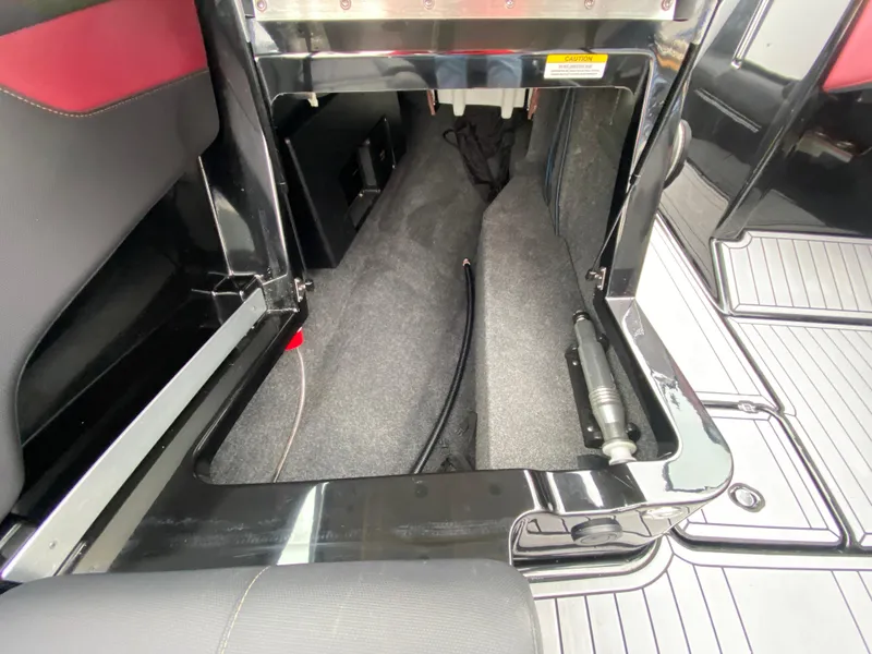 Slide: The Image of 2022 MasterCraft XT24 boat storage compartment with sleek interior design. - 21