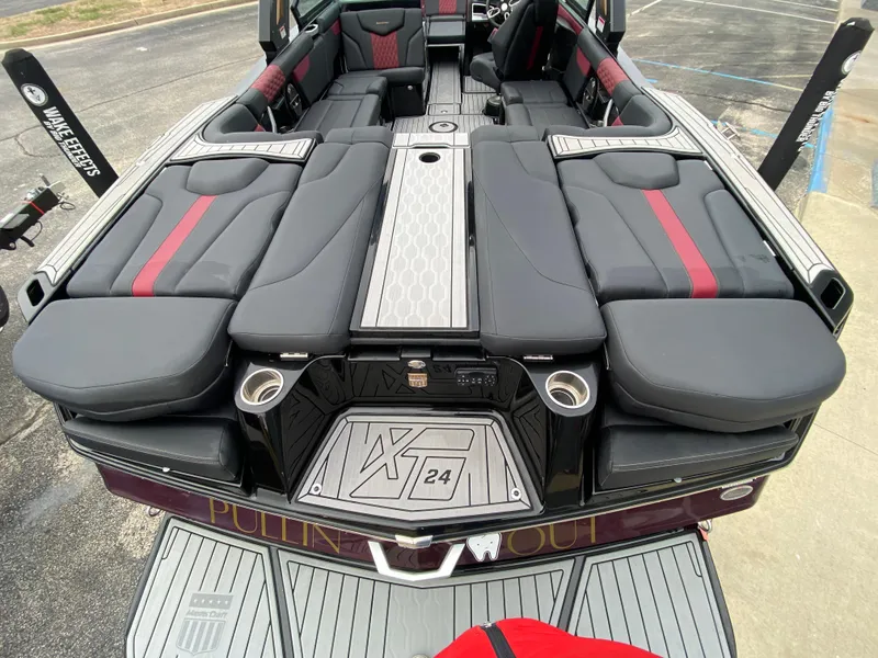 Slide: The Image of 2022 MasterCraft XT24 boat interior with sleek black and red seating. - 9