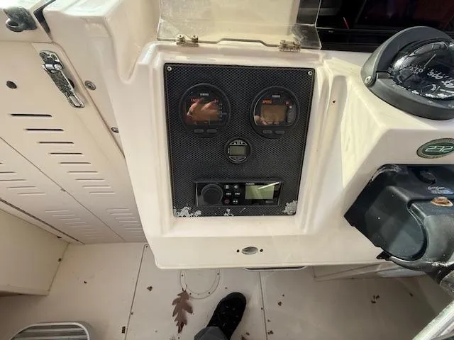 Slide: The Image of Control panel of 2002 Grady-White 232 Gulfstream boat with gauges and compass. - 11