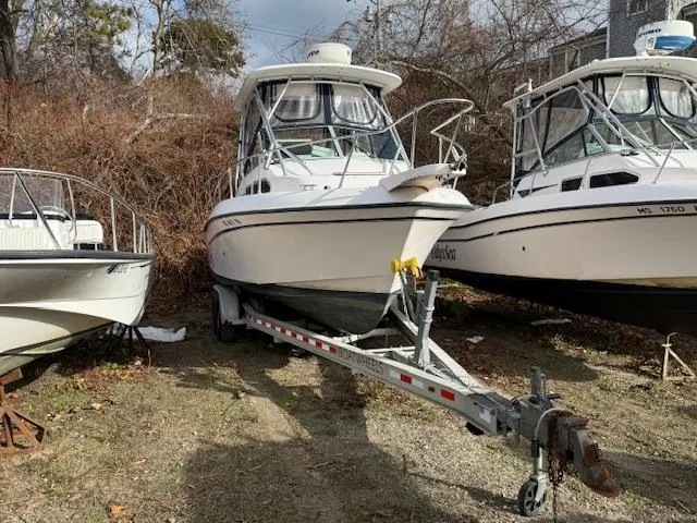 Slide: The Image of 2002 Grady-White 232 Gulfstream boat on trailer, parked outdoors. - 2