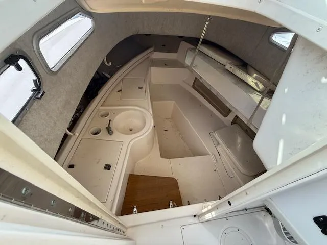 Slide: The Image of Interior of 2002 Grady-White 232 Gulfstream boat, featuring compact cabin layout. - 8